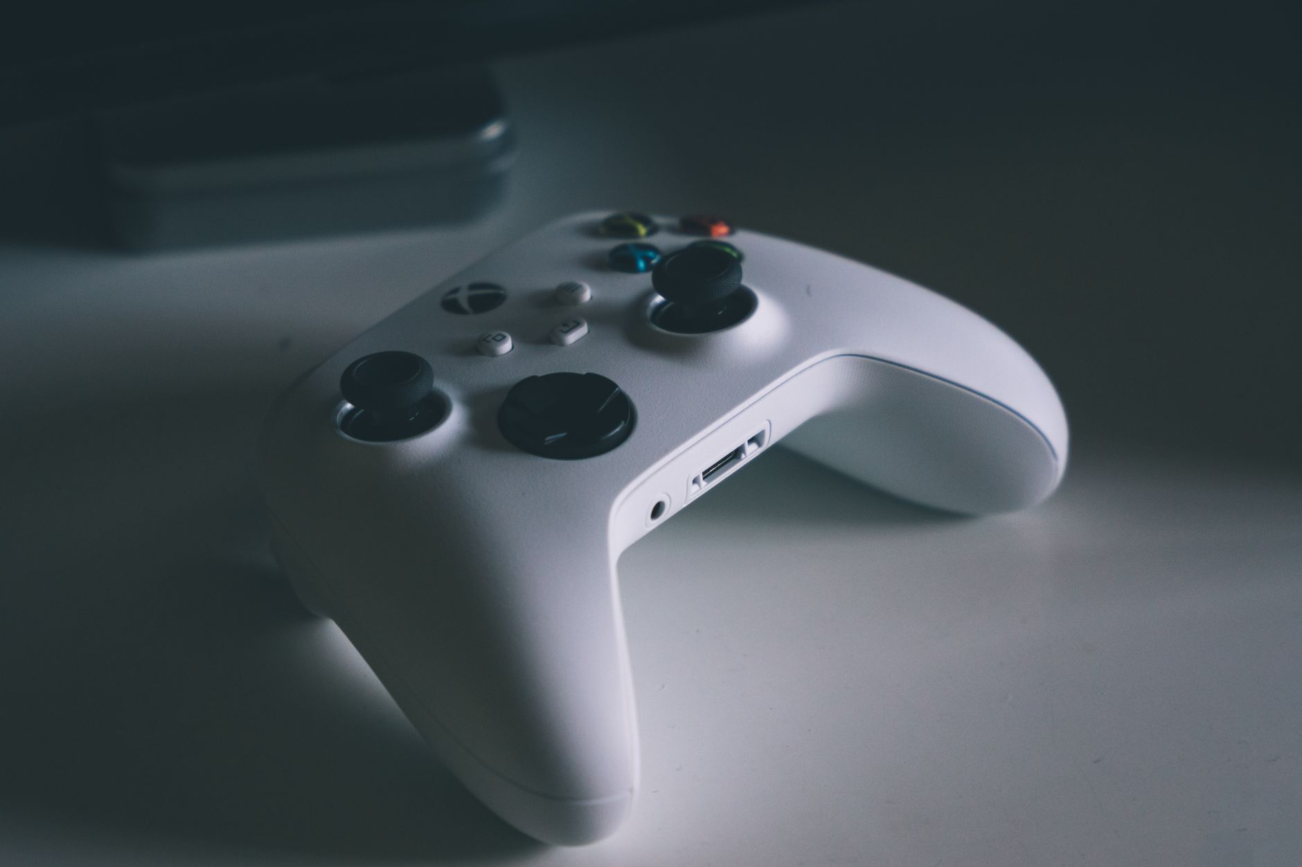 A detailed shot of a white gaming controller on a desk surface, perfect for tech and gaming themes. — Enhance Your Betting Ex