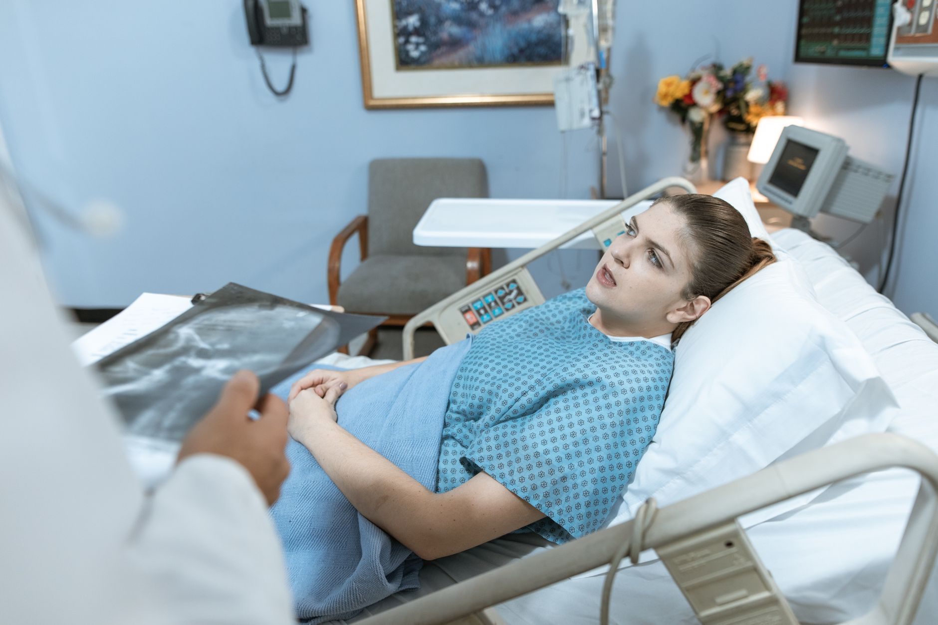 Caucasian woman in hospital bed receiving care from healthcare professional. — Experience Sensual Healing with Tantric Massag