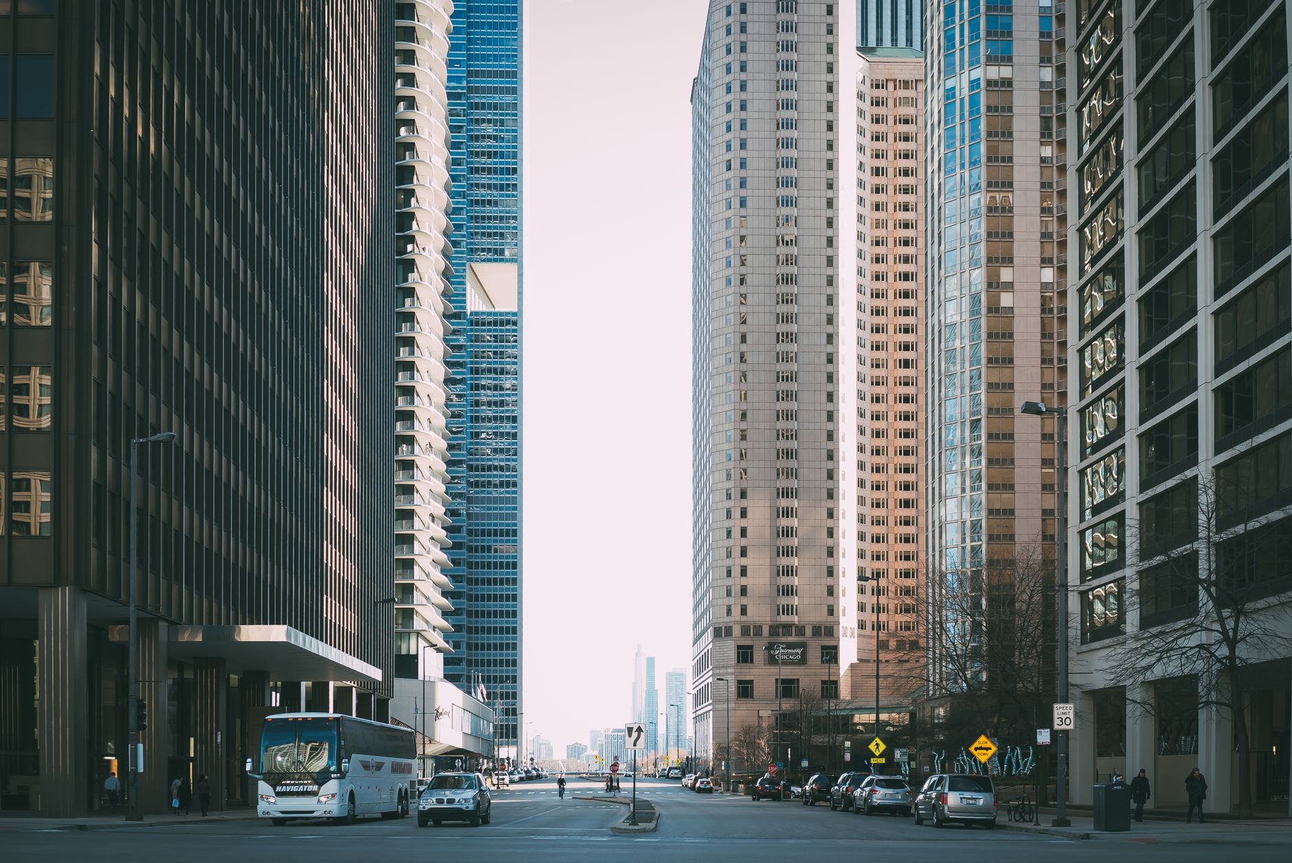 Vibrant city street scene with tall skyscrapers and city life full of cars and pedestrians. — Mailbox Wholesale: Meet High Vo