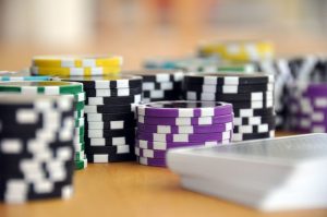 A close-up shot of stacked poker chips and playing cards on a table, perfect for casino and gambling themes. — Professional G