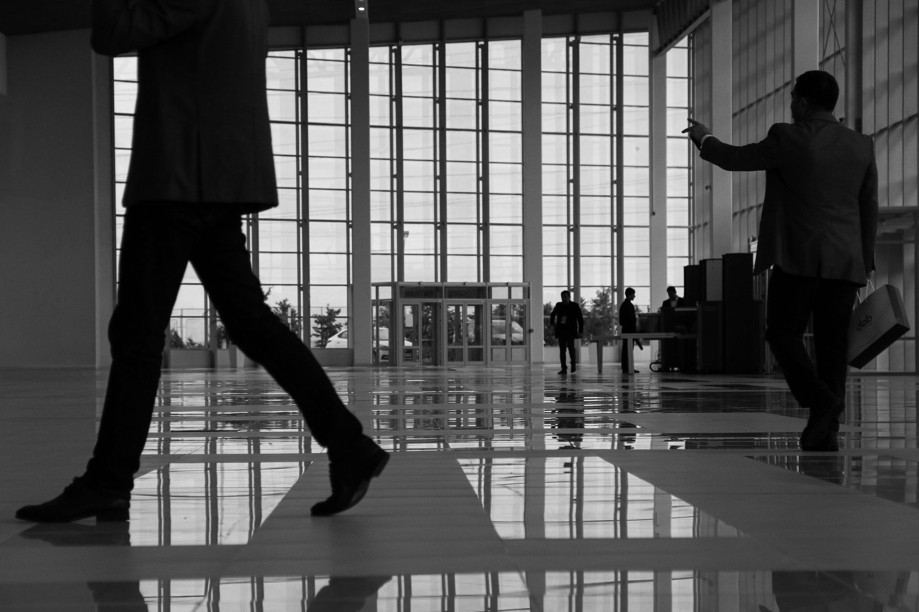 Business professionals walk through a modern, glass-paneled indoor space. — The Path to Prosperity: How Cassie Finance Drives